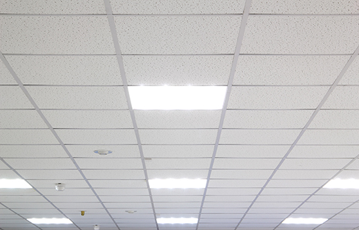 Acoustic ceiling tiles for soundproofing a room with NetWell Noise Control.