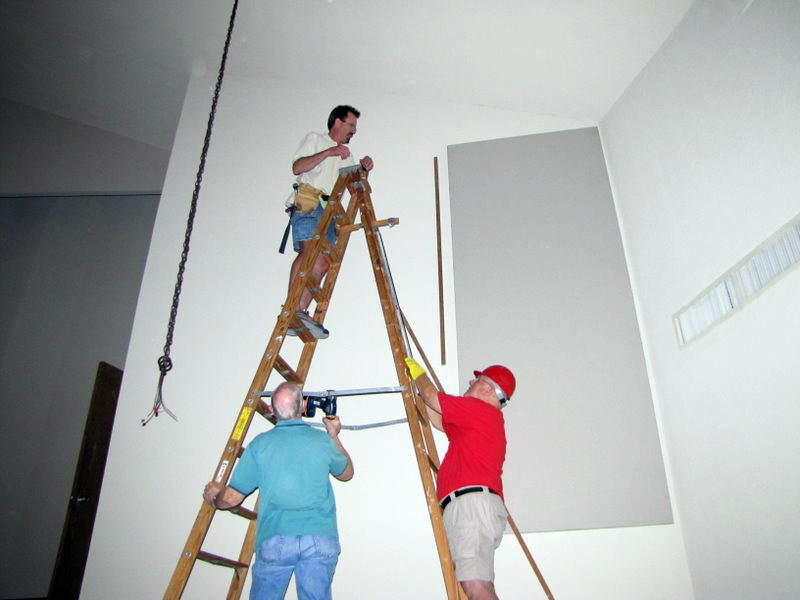 installing sound panels on a wall