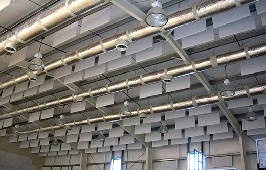 white acoustic sound baffles controlling excessive noise levels in a natatorium