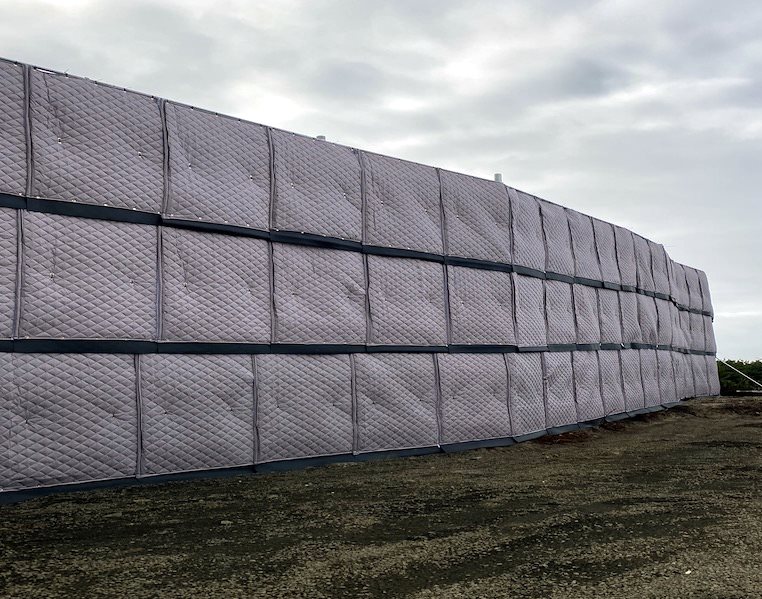 outdoor sound blankets attached to fence