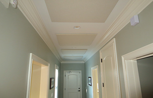 office noise control with ceiling mounted acoustic panels in a hallway