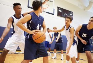 Crowd noise at basketball games controlled by the sound panels supplied by NetWell Noise Control for gym soundproofing.