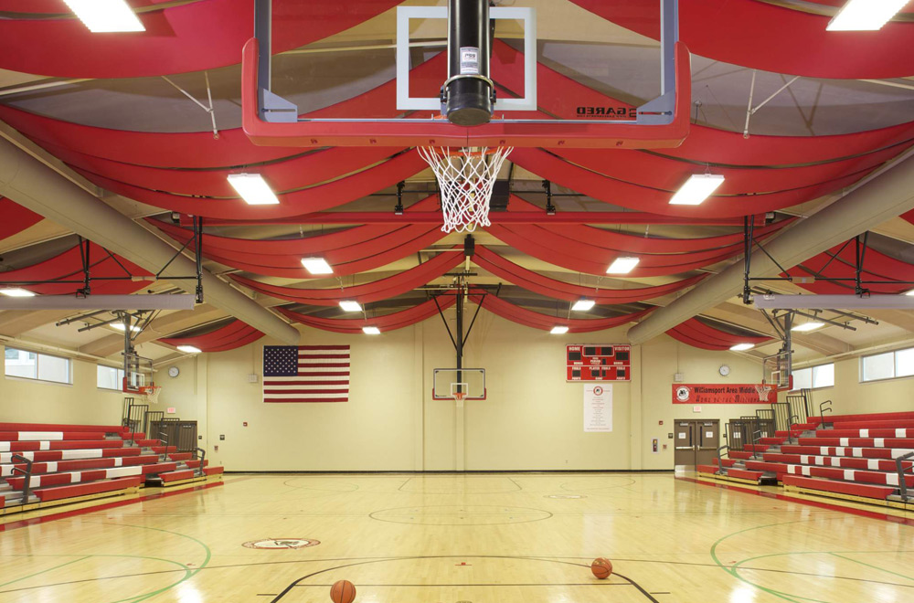 red pvc wrapped acoustic ceiling panels in a gym